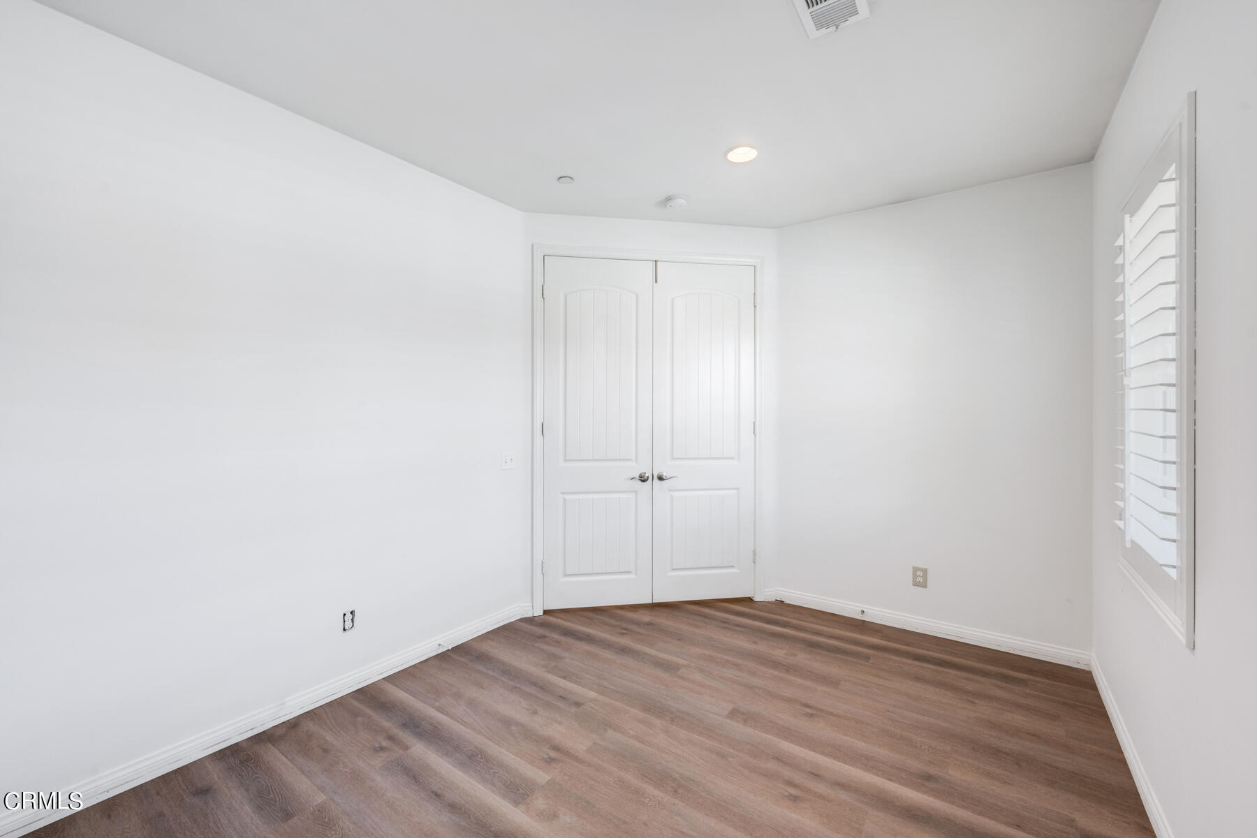 7332 Blue Oak Road Riverside, CA 92507 - Photo 11 of 30 an empty room with wooden floor and windows