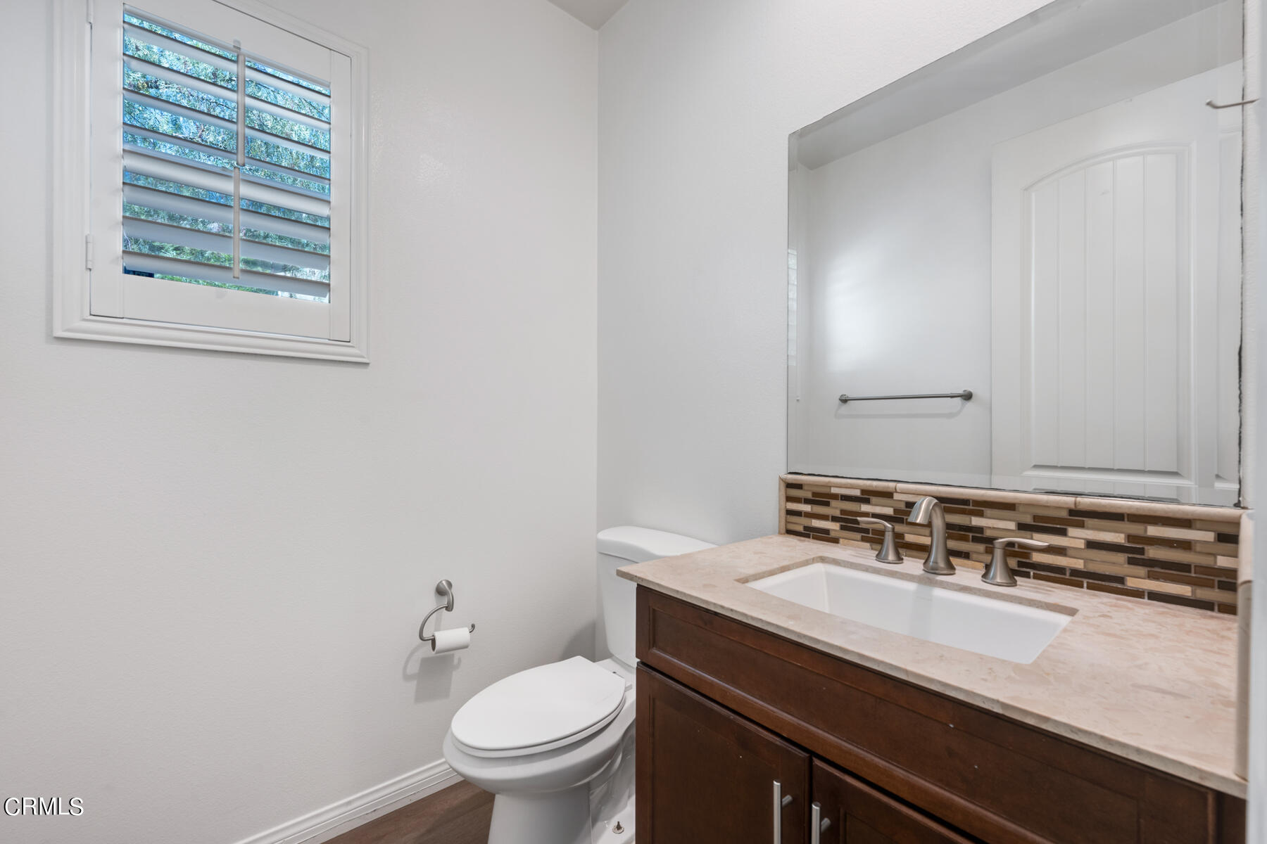 7332 Blue Oak Road Riverside, CA 92507 - Photo 12 of 30 a bathroom with a sink a toilet a mirror and a window