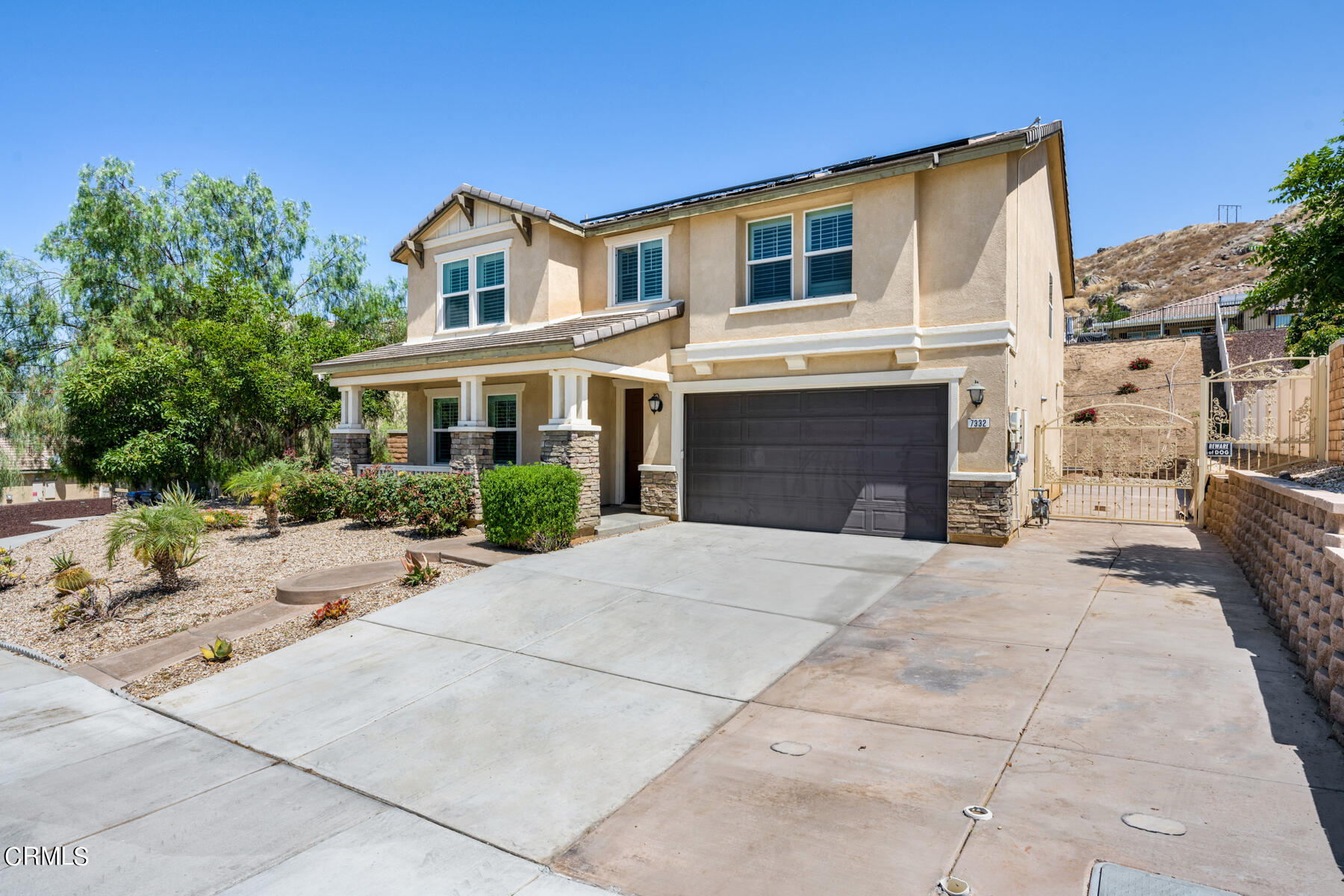 7332 Blue Oak Road Riverside, CA 92507 - Photo 2 of 30 a front view of a house with a yard and garage