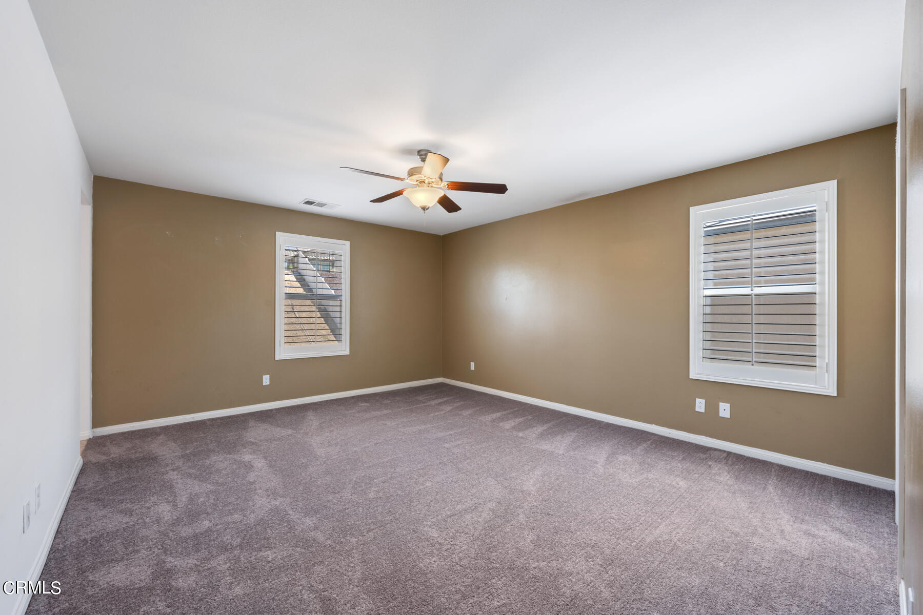 7332 Blue Oak Road Riverside, CA 92507 - Photo 23 of 30 an empty room with windows and chandelier fan