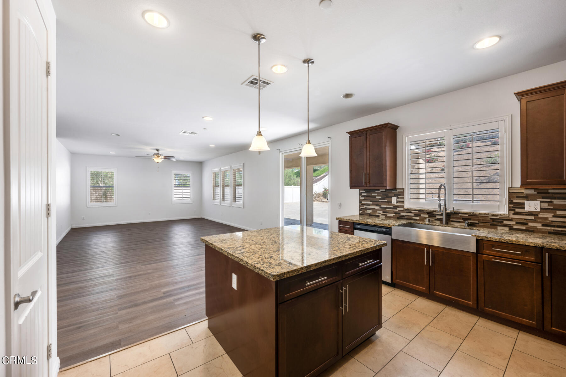 7332 Blue Oak Road Riverside, CA 92507 - Photo 6 of 30 a large kitchen with stainless steel appliances granite countertop a stove and a sink