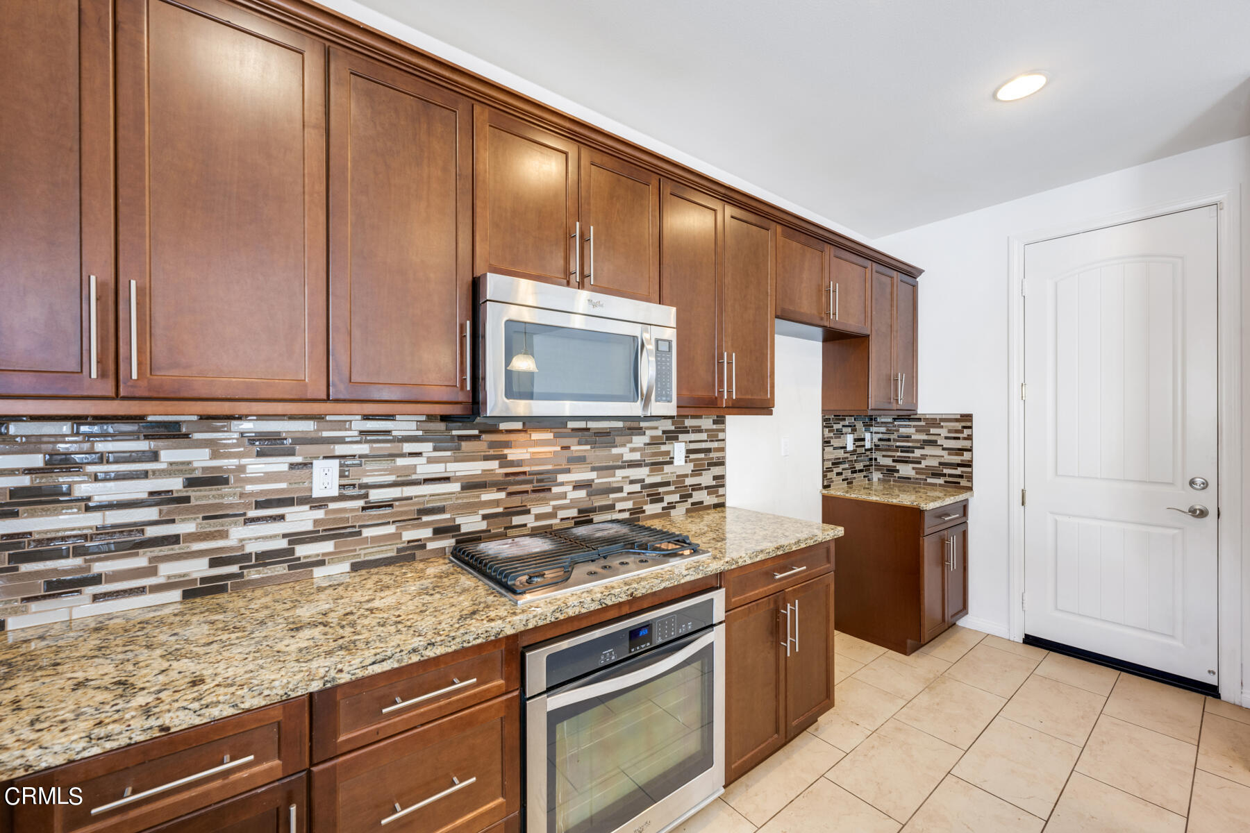 7332 Blue Oak Road Riverside, CA 92507 - Photo 7 of 30 a kitchen with stainless steel appliances granite countertop a sink stove and cabinets