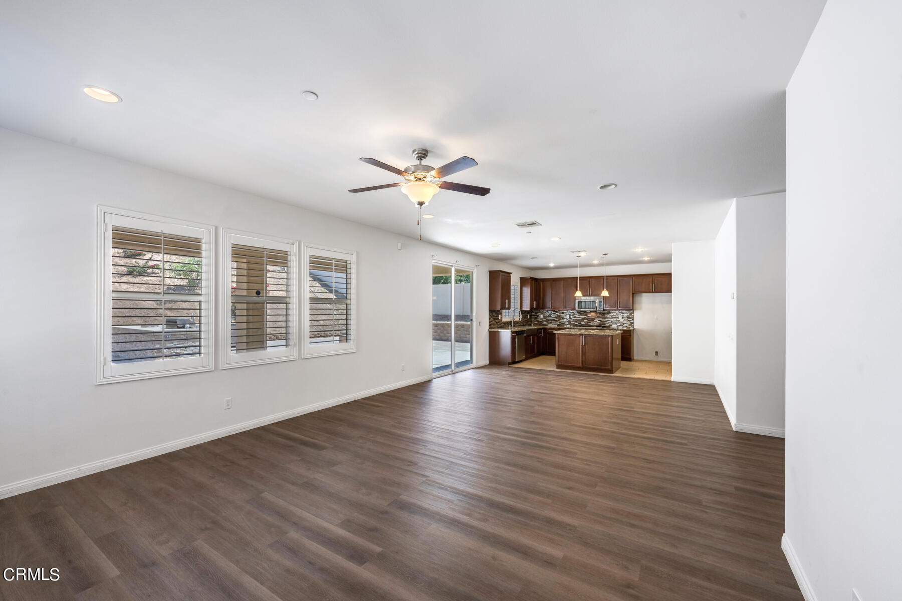 7332 Blue Oak Road Riverside, CA 92507 - Photo 8 of 30 a view of an empty room with a window and wooden floor
