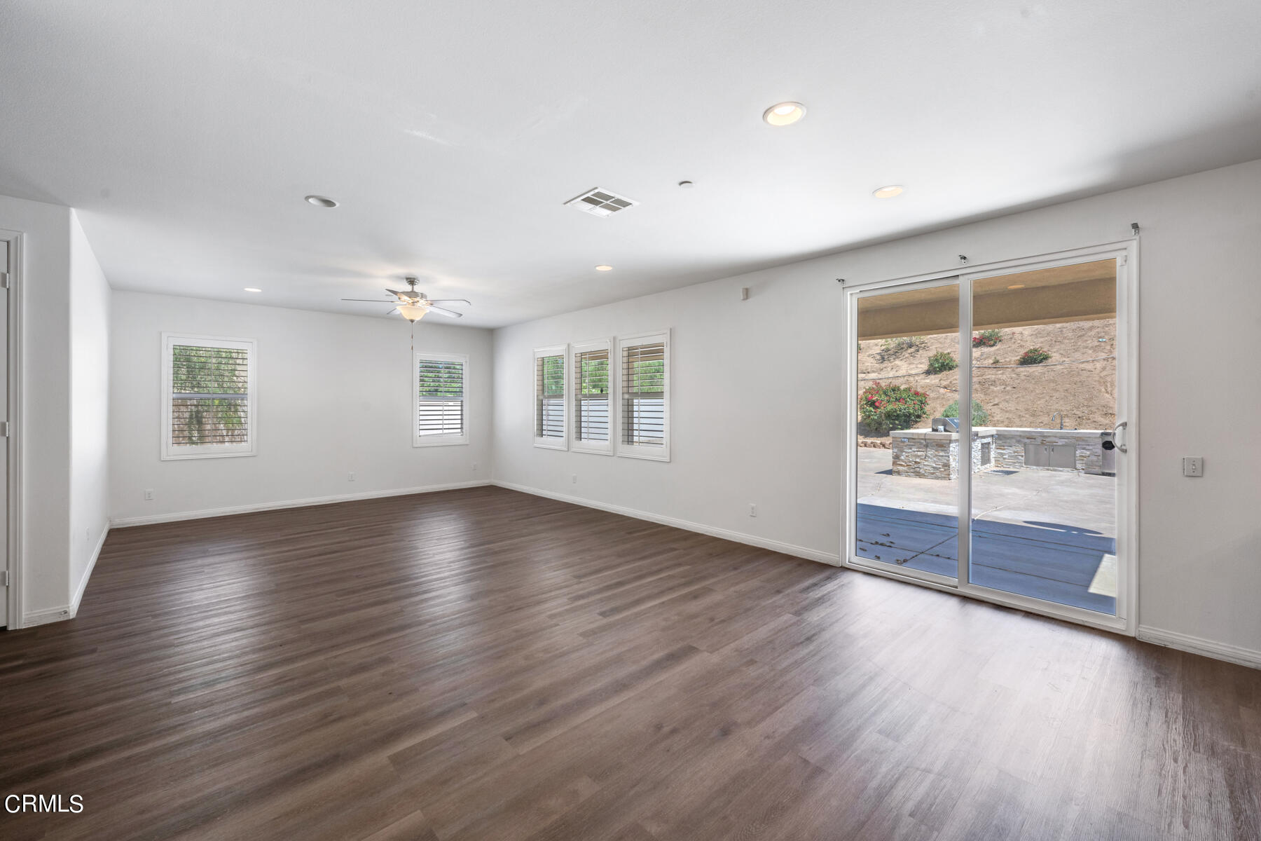 7332 Blue Oak Road Riverside, CA 92507 - Photo 9 of 30 a view of an empty room with wooden floor and a window