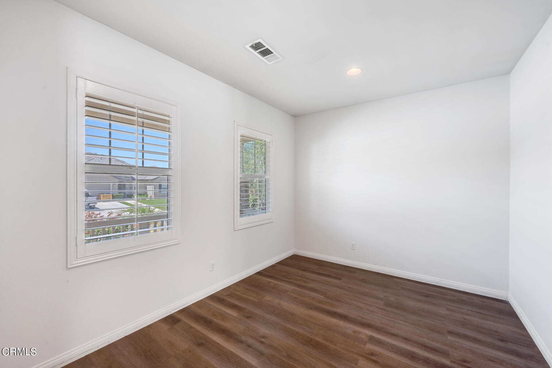 7332 Blue Oak Road Riverside, CA 92507 - Photo 10 of 30 an empty room with wooden floor and windows