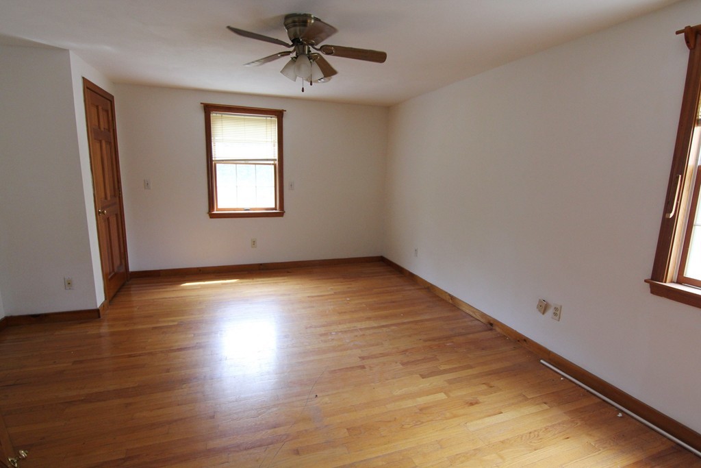 54 Middle Road Newbury, MA 01951 - Photo 5 of 13 a view of empty room with wooden floor and fan