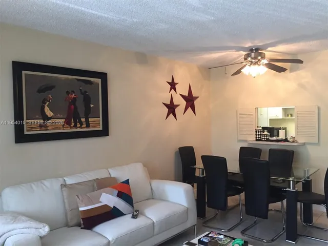 a living room with furniture a couch and a chandelier