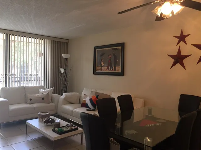 a living room with furniture a lamp and a window