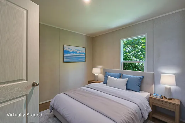 a bedroom with a bed and a window