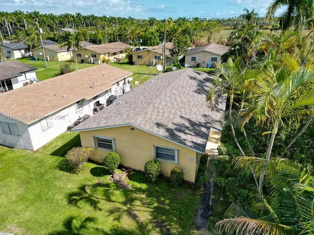 an aerial view of multiple houses with yard