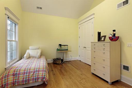 606 Locust Road Wilmette, IL 60091 - Photo 11 of 13 a bedroom with a bed and wooden floor