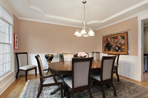 606 Locust Road Wilmette, IL 60091 - Photo 3 of 13 a view of a dining room with furniture a chandelier and wooden floor