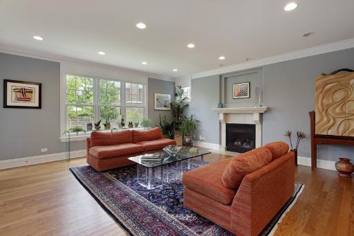 606 Locust Road Wilmette, IL 60091 - Photo 4 of 13 a living room with furniture a fireplace and a floor to ceiling window