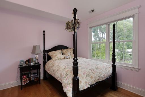 606 Locust Road Wilmette, IL 60091 - Photo 9 of 13 a bedroom with a bed and a chandelier