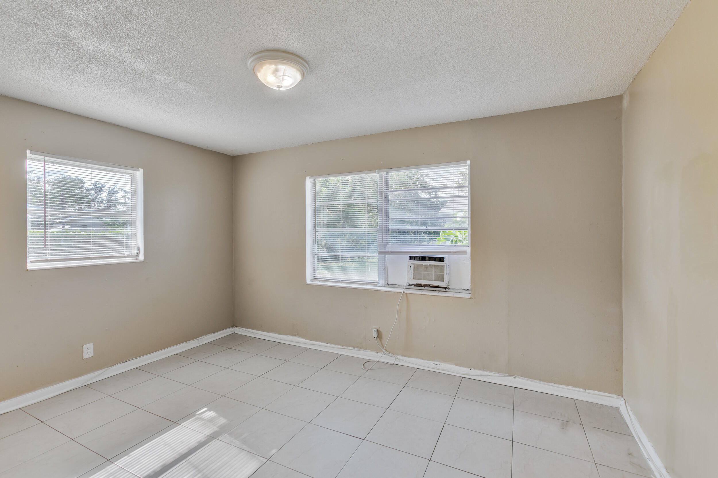 461 Silver Beach Road, Unit 1 Riviera Beach, FL 33403 - Photo 26 of 33 an empty room with windows