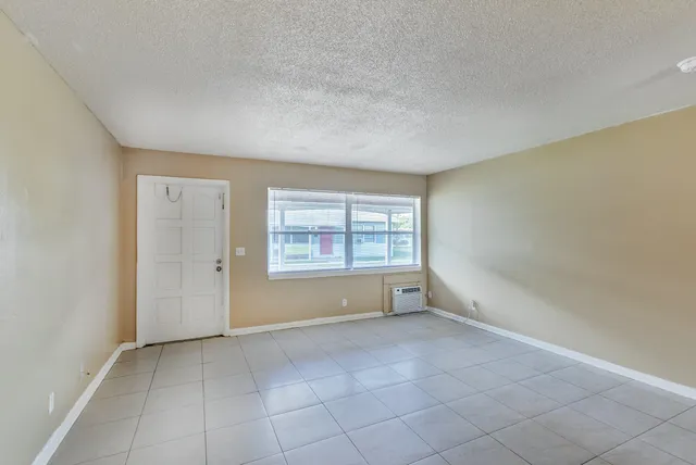 a view of an empty room and a window