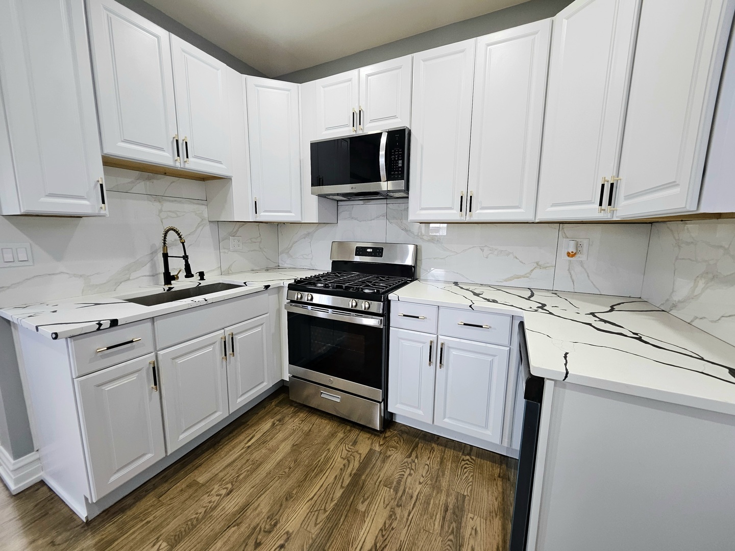 8817 South Morgan Street Chicago, IL 60620 - Photo 12 of 37 a kitchen with granite countertop white cabinets and white appliances