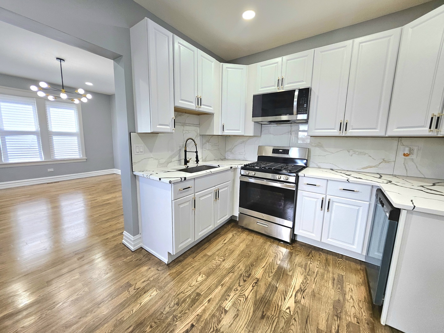 8817 South Morgan Street Chicago, IL 60620 - Photo 13 of 37 a kitchen with granite countertop a sink cabinets and stainless steel appliances