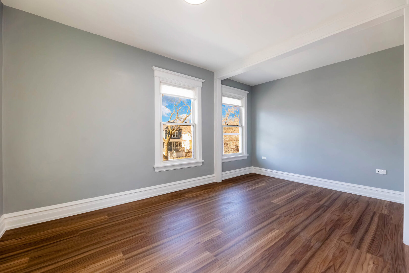 8817 South Morgan Street Chicago, IL 60620 - Photo 15 of 37 a view of an empty room with wooden floor and window