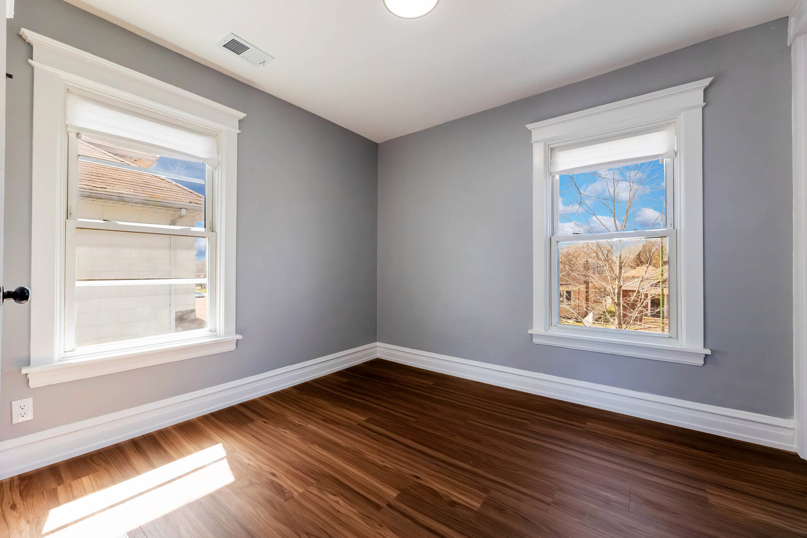 8817 South Morgan Street Chicago, IL 60620 - Photo 16 of 37 a view of an empty room with wooden floor and a window