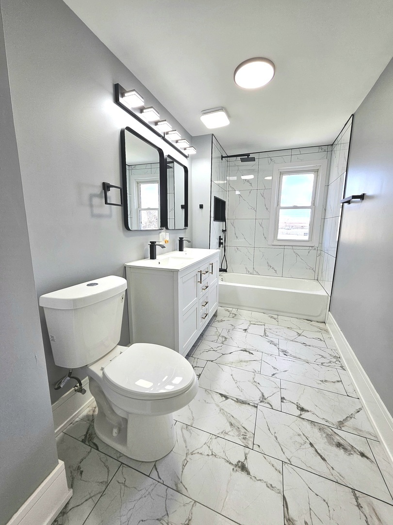 8817 South Morgan Street Chicago, IL 60620 - Photo 18 of 37 a bathroom with a toilet sink and mirror