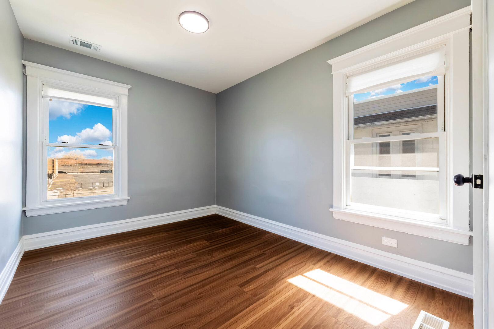 8817 South Morgan Street Chicago, IL 60620 - Photo 20 of 37 a view of an empty room window and wooden floor