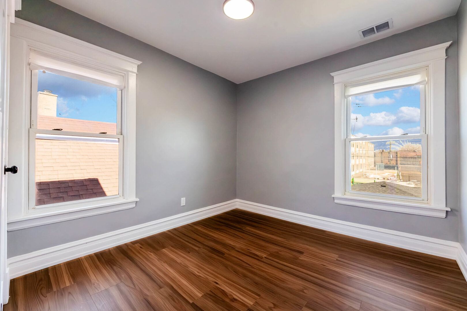 8817 South Morgan Street Chicago, IL 60620 - Photo 21 of 37 a view of an empty room with wooden floor and a window