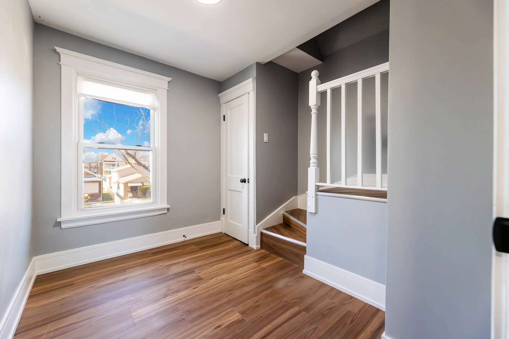 8817 South Morgan Street Chicago, IL 60620 - Photo 22 of 37 an empty room with wooden floor and a window