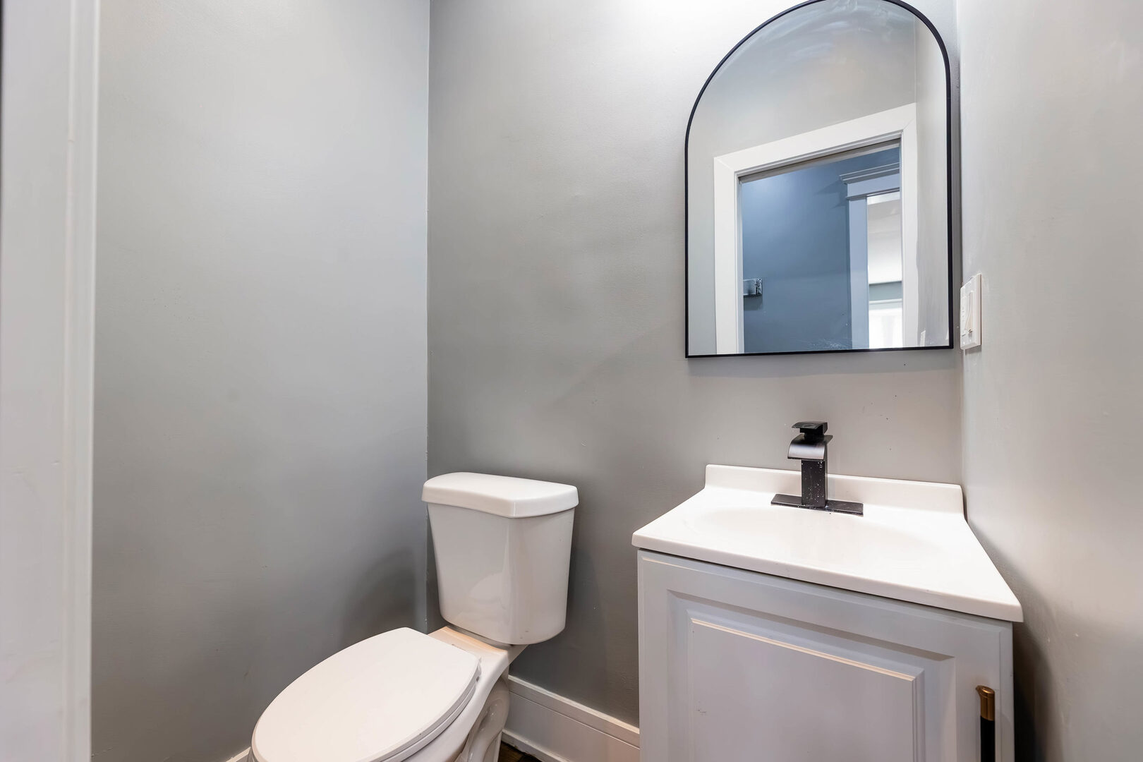 8817 South Morgan Street Chicago, IL 60620 - Photo 23 of 37 a bathroom with a toilet sink and mirror