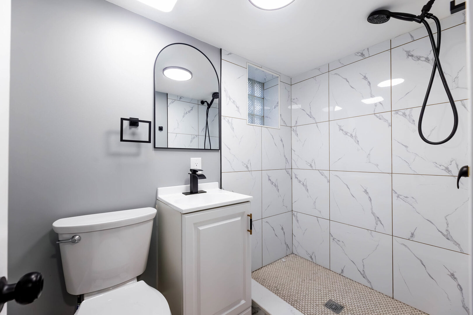 8817 South Morgan Street Chicago, IL 60620 - Photo 29 of 37 a bathroom with a toilet sink and mirror
