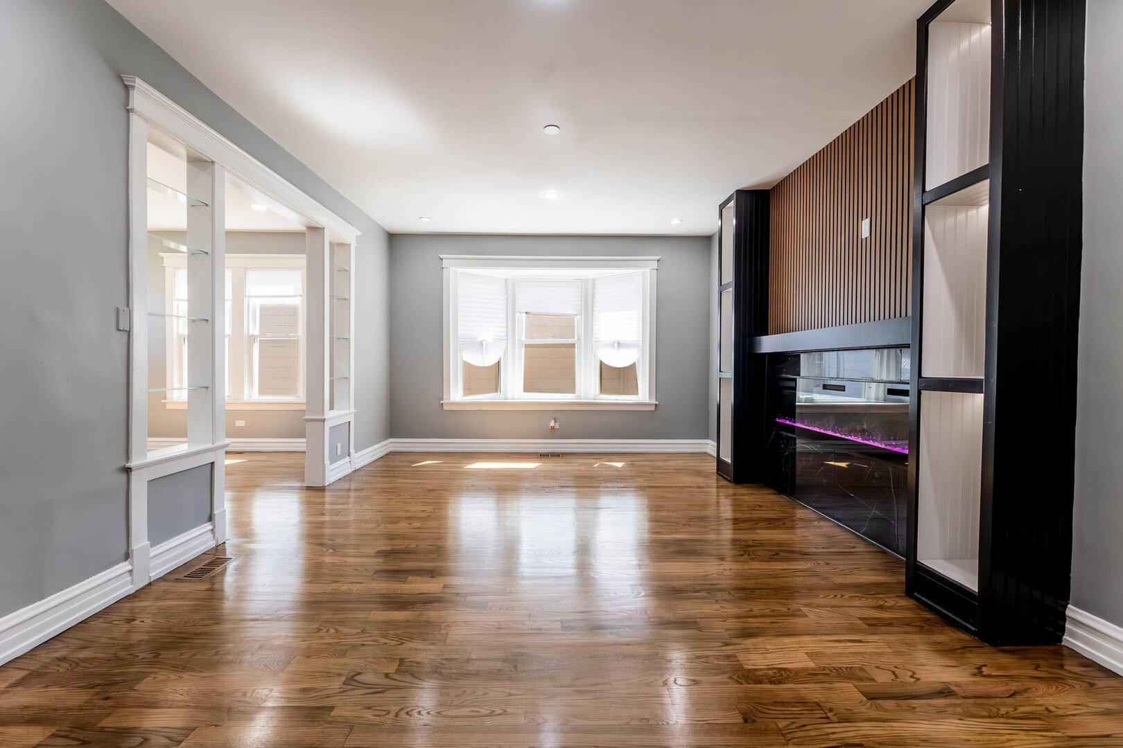 8817 South Morgan Street Chicago, IL 60620 - Photo 6 of 37 a view of empty room with wooden floor and fan