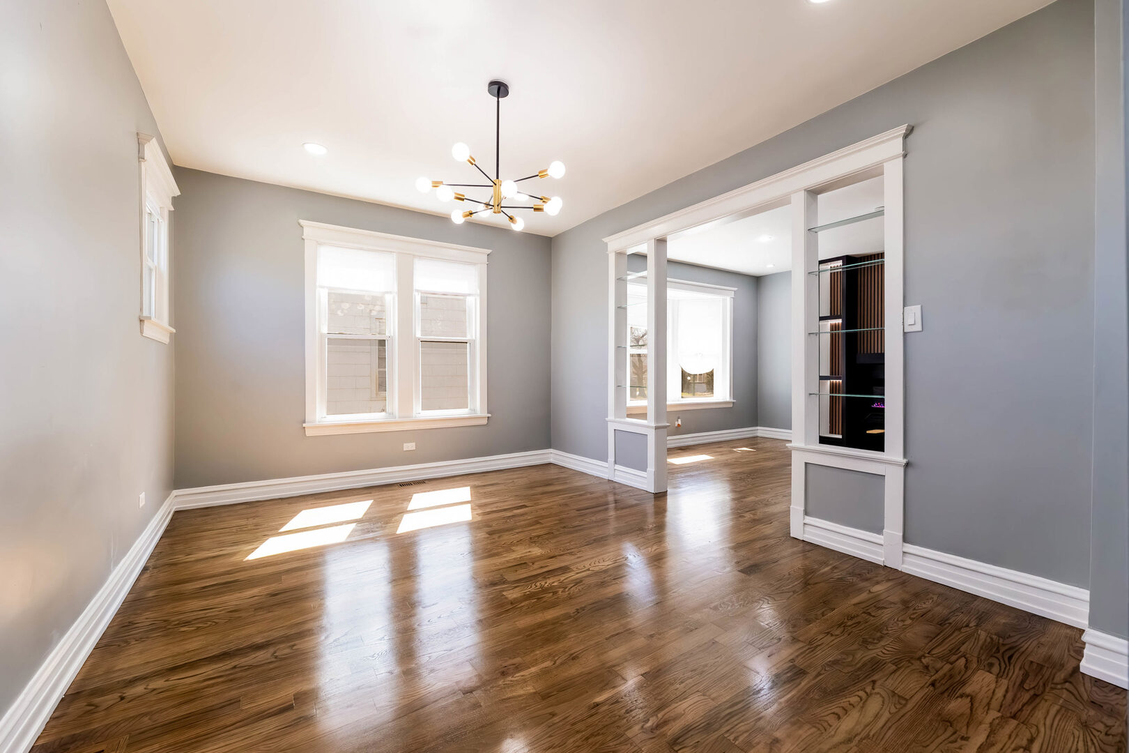 8817 South Morgan Street Chicago, IL 60620 - Photo 9 of 37 a view of an empty room with wooden floor and a window