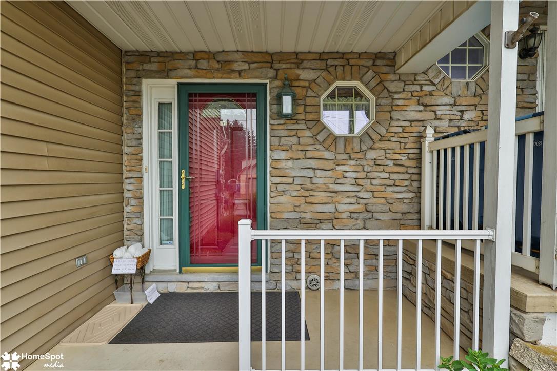 507 Howertown Road Northampton, PA 18067 - Photo 2 of 46 A welcoming stone and siding facade creates appealing curb appeal with a vibrant red entry door.