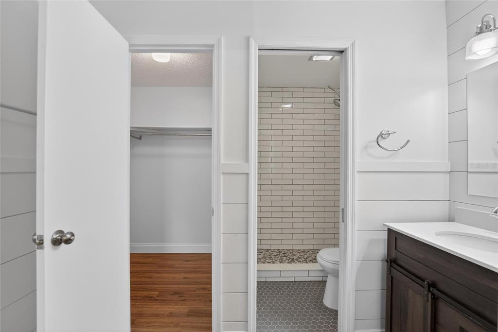 2340 Merrily Circle South Seffner, FL 33584 - Photo 22 of 52 a bathroom with a granite countertop toilet a sink and a mirror