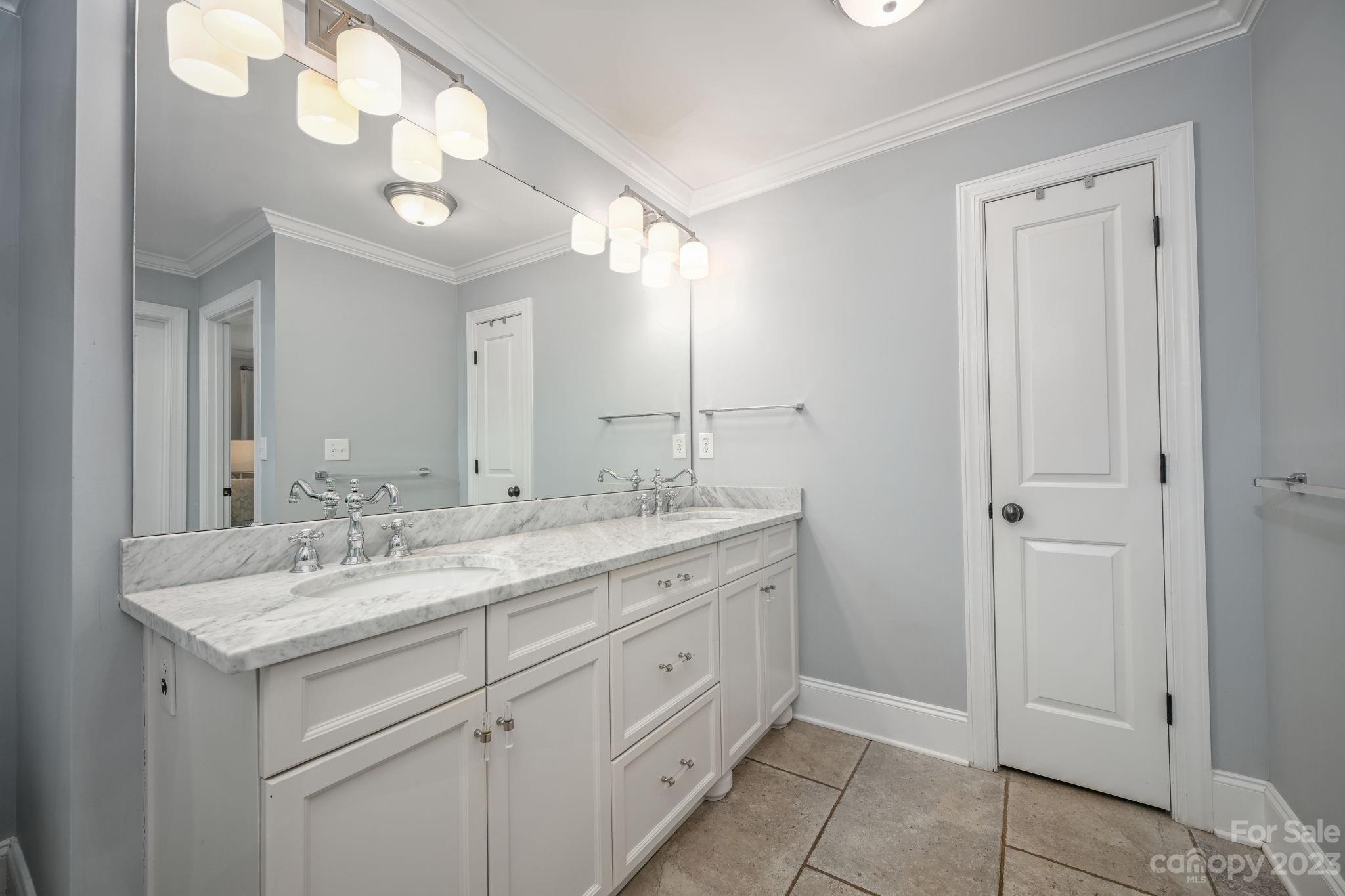 1001 Sedgefield Road Charlotte, NC 28209 - Photo 16 of 30 a bathroom with a granite countertop sink a light fixture and a mirror