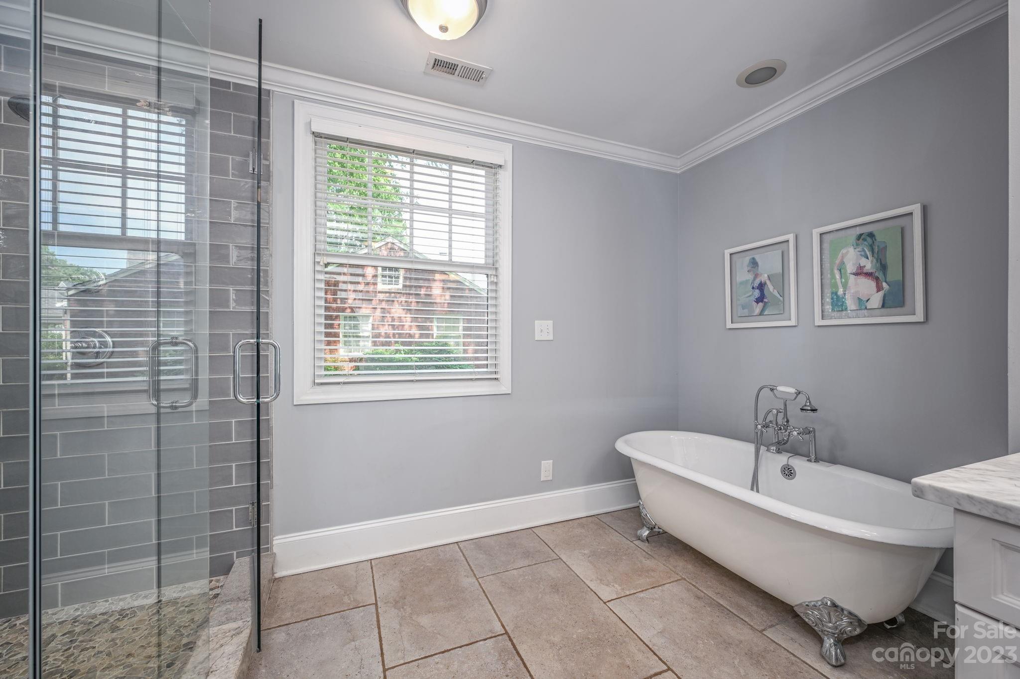 1001 Sedgefield Road Charlotte, NC 28209 - Photo 17 of 30 a bathroom with a bathtub and window