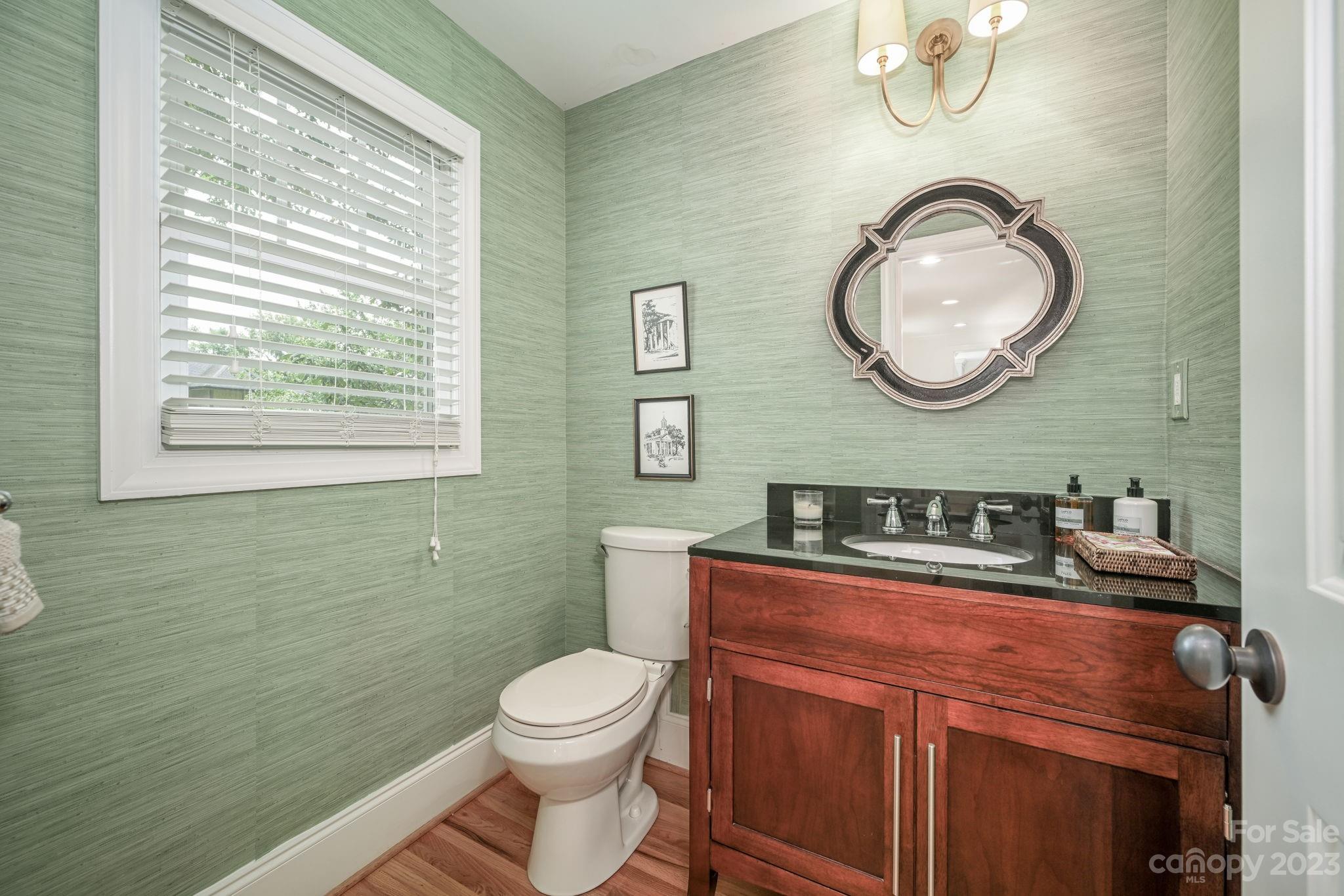 1001 Sedgefield Road Charlotte, NC 28209 - Photo 18 of 30 a bathroom with a toilet a sink and mirror