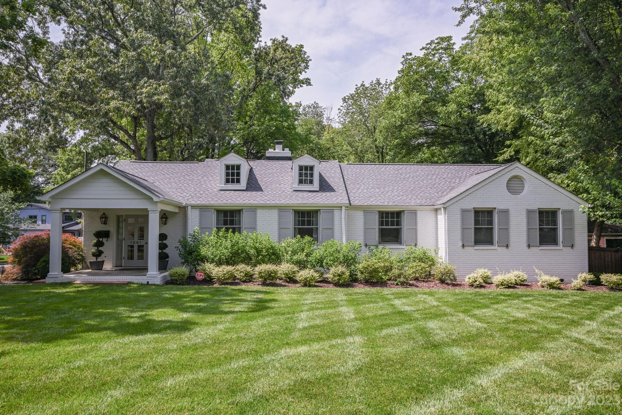1001 Sedgefield Road Charlotte, NC 28209 - Photo 2 of 30 a front view of a house with a yard and potted plants