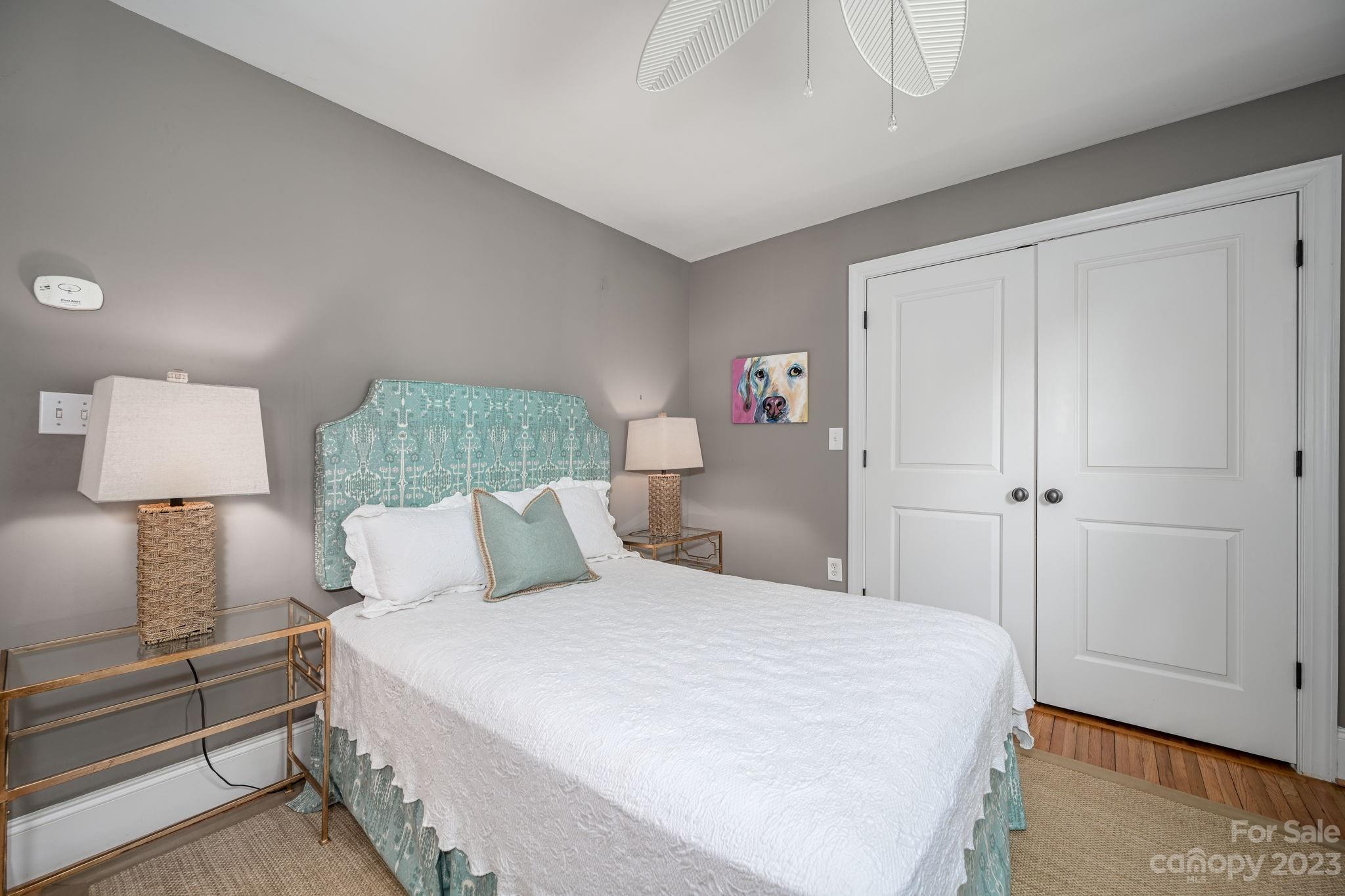 1001 Sedgefield Road Charlotte, NC 28209 - Photo 21 of 30 a bedroom with a bed and a lamp
