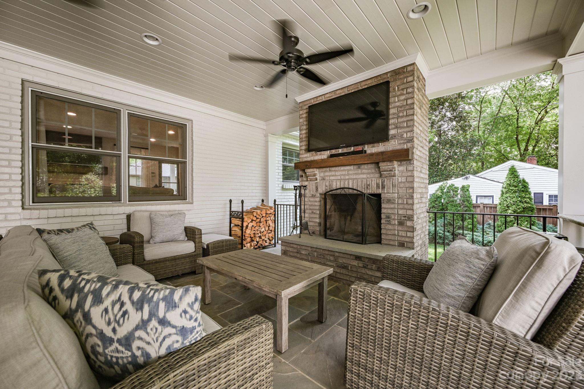 1001 Sedgefield Road Charlotte, NC 28209 - Photo 24 of 30 a living room with furniture a fireplace and a flat screen tv