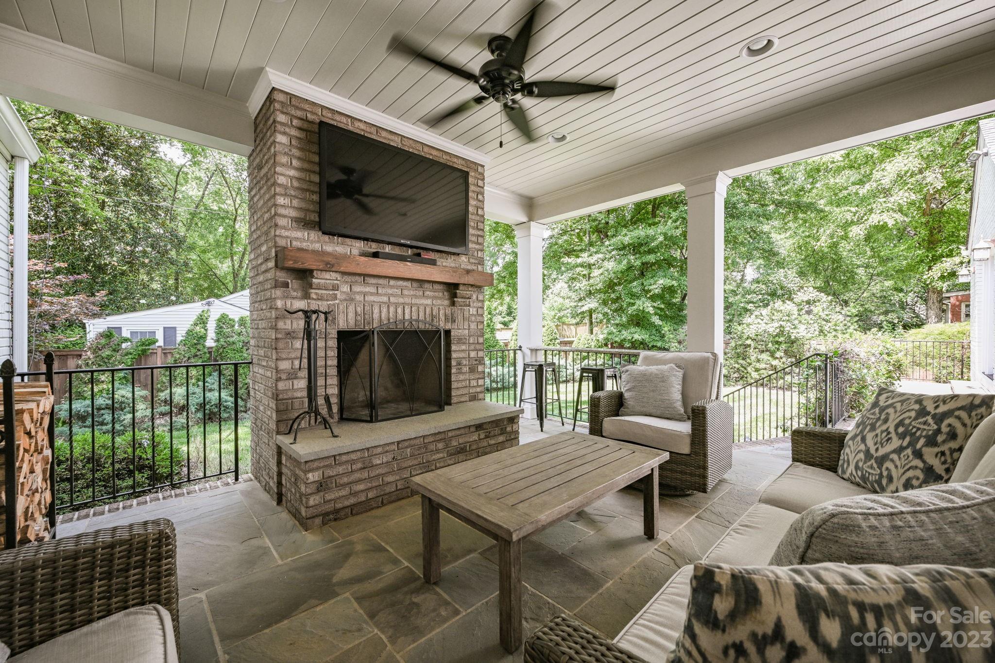 1001 Sedgefield Road Charlotte, NC 28209 - Photo 25 of 30 a living room with furniture a flat screen tv and a fireplace