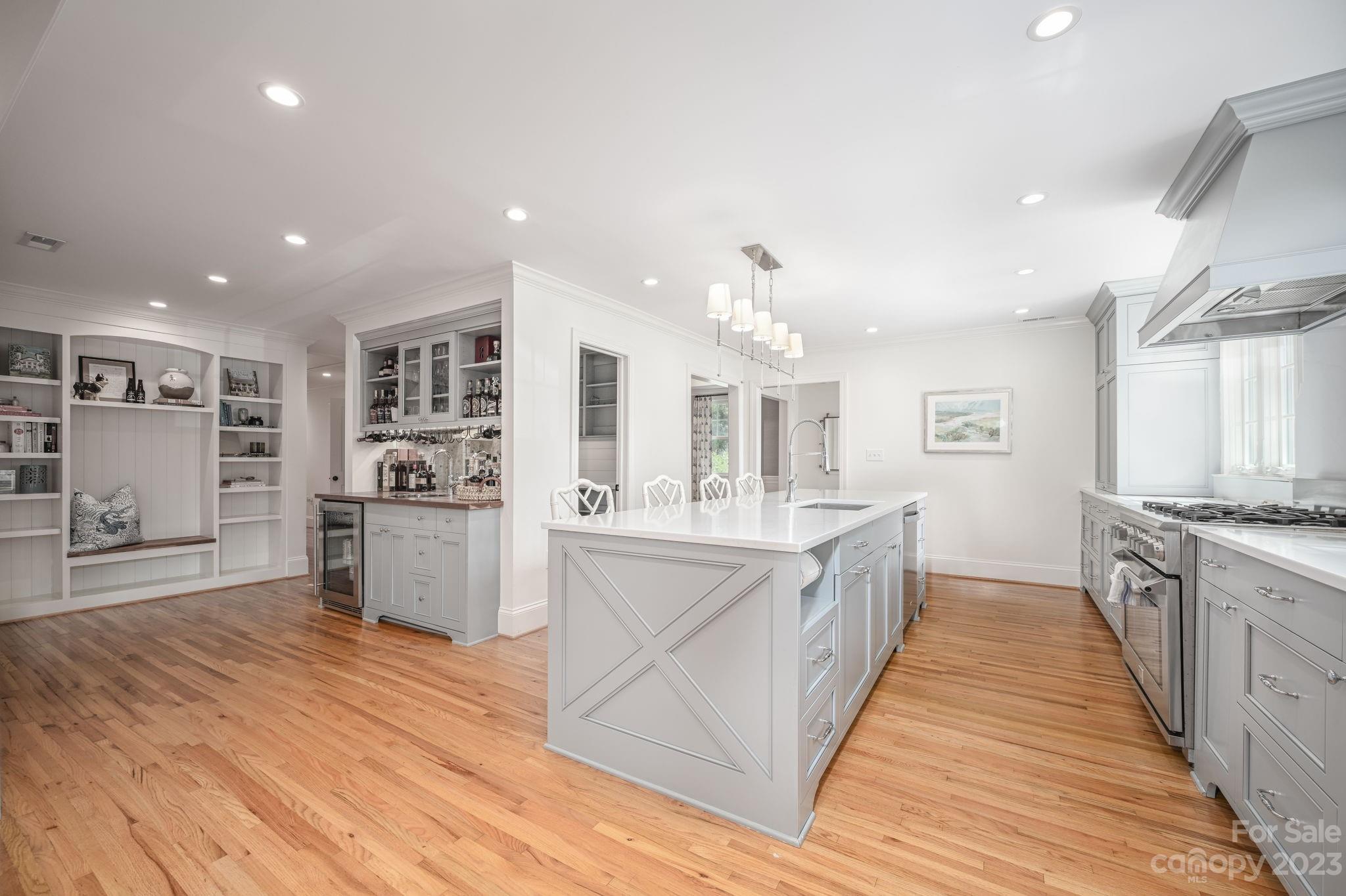 1001 Sedgefield Road Charlotte, NC 28209 - Photo 8 of 30 a large kitchen with stainless steel appliances lots of counter space and wooden floor