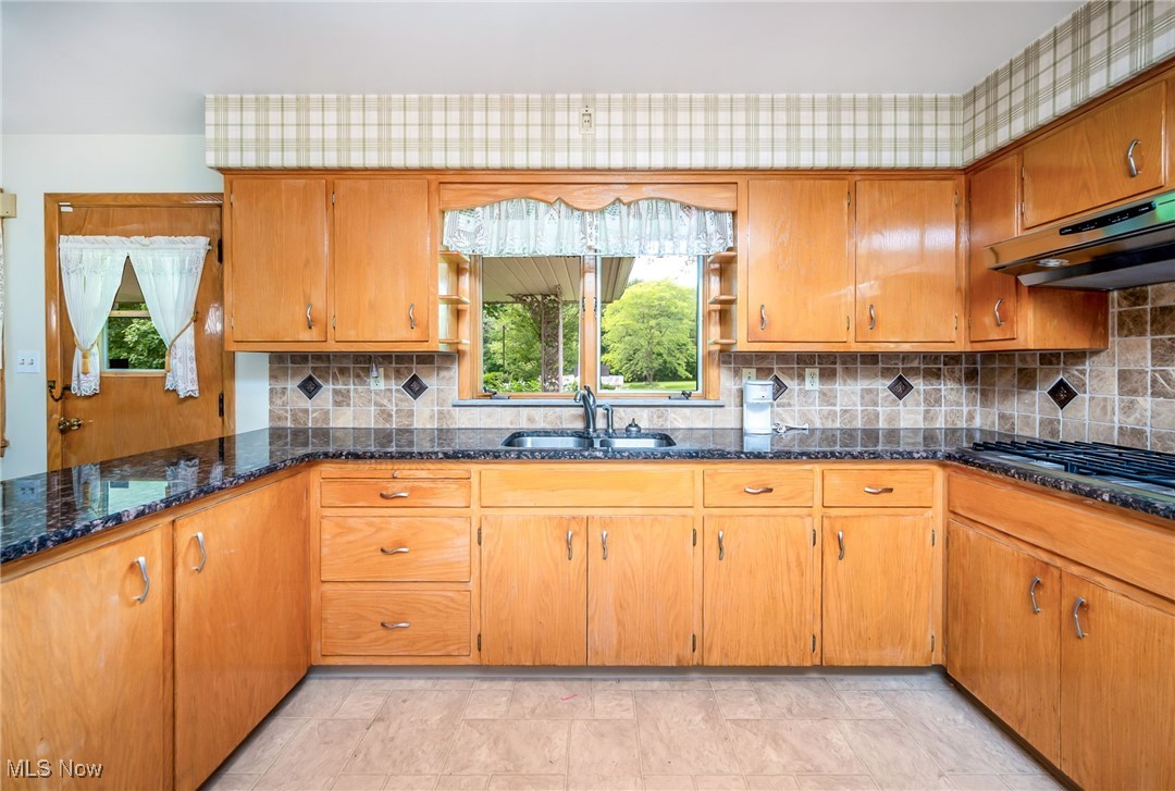 126 South Rhodes Avenue Niles, OH 44446 - Photo 8 of 23 Kitchen with backsplash, sink, light tile flooring, and range hood