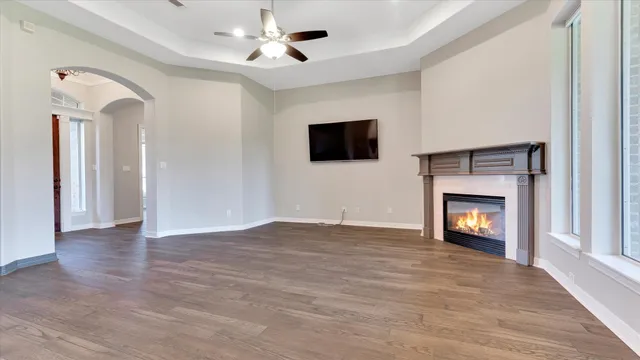 a view of an empty room with a fireplace and a window