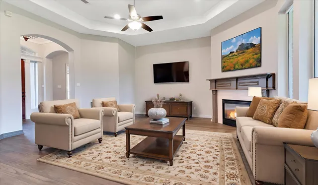 a living room with furniture a flat screen tv and a fireplace