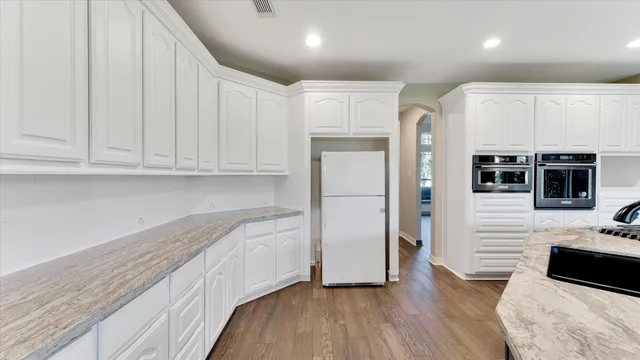 a kitchen with stainless steel appliances granite countertop a refrigerator and a microwave