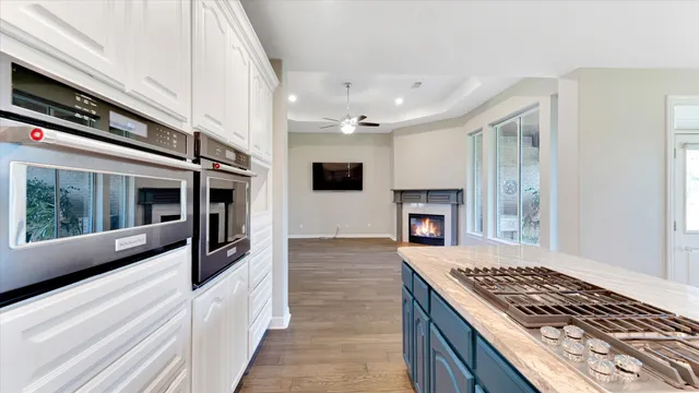 a kitchen with stainless steel appliances granite countertop a stove and a refrigerator
