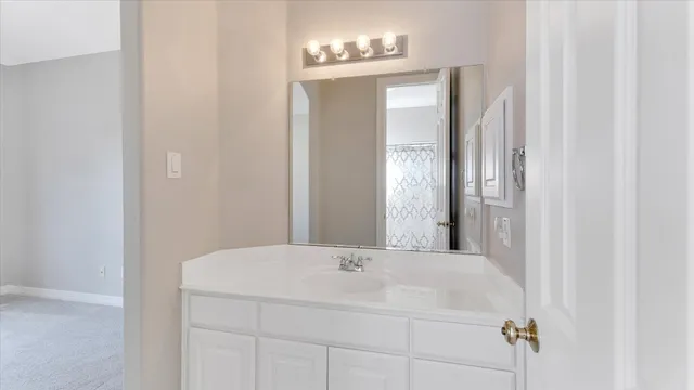 a bathroom with a bathtub and a mirror