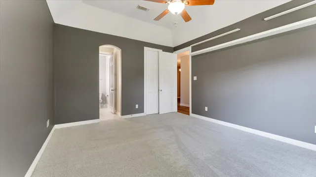 a view of a livingroom with a ceiling fan and window
