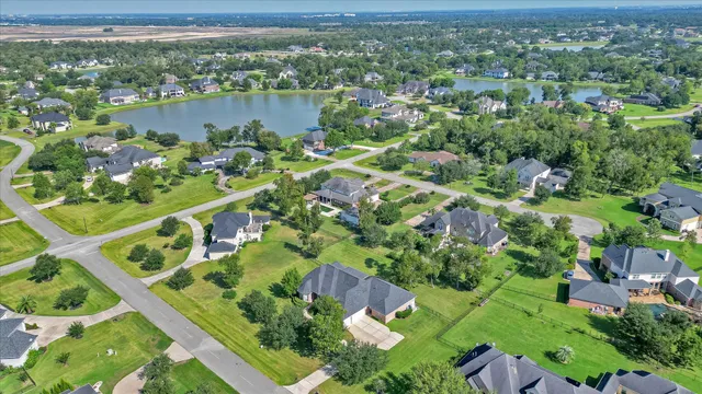 an aerial view of lake residential houses with outdoor space and trees